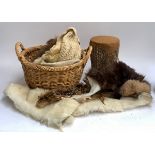 A wicker basket containing a quantity of fur, etc