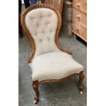 A Victorian carved walnut buttonback salon chair, serpentine seat on carved cabriole legs, with