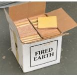 A box of pale yellow fired earth tiles, approx. 80, each tile approx. 11x11cm