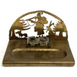 A brass desk stand with pierced huntsman scene, containing two cut glass inkwells, 24cmW