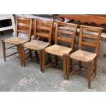 A lot of four oak pew chairs, with rush seats and double H stretchers