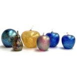 Four iridescent art glass apple paperweights, a similar pear, and an art glass egg by Juliet