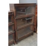 An oak Globe-Wernicke four section bookcase, each section with plaque, 88x29x136cm