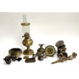 A mixed lot of mainly metal items to include die cutting pieces; model cannons; oil lamp; wall