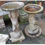 Two composite stone garden birdbaths, each supported by figures, the tallest 76cmH