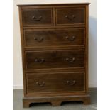 An early 20th century mahogany chest of two short over three long drawers, barbers pole stringing,