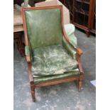 A green leather armchair, carved frame on tapering legs, 67cmW