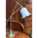 An adjustable brass table lamp, with milk glass shade, approx. 46cmH