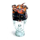 An early 20th century Chinese silk ceremonial child's tiger wind hat, with embroidered and applied