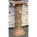 A decorative carved wooden pedestal, with grape and vine decoration, 72cmH