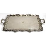 A large silver plated tray with shaped edge with scallop shells, monogrammed 'H', 73x48cm