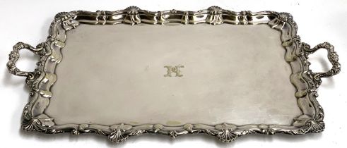 A large silver plated tray with shaped edge with scallop shells, monogrammed 'H', 73x48cm