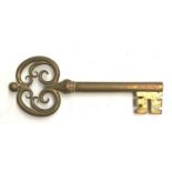 A very large decorative brass key, 37cmL