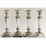 A lot of four plated neoclassical style candlesticks, removable nozzles, gadrooned borders, and