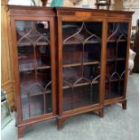 A Victorian astragal glazed mahogany and satinwood banded breakfront bookcase, on swept bracket