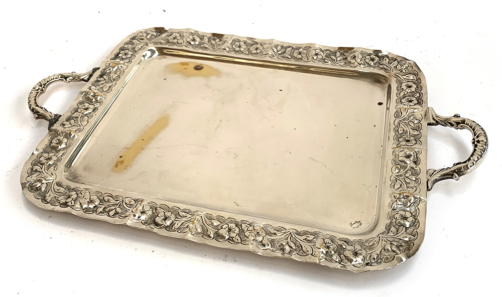 A silver coloured oblong tray stamped Argent 1000, with later loop handles and an embossed flower