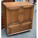A modern Ercol elm cabinet, hinged and sliding doors, over a single drawer, on casters, 85x51cmH