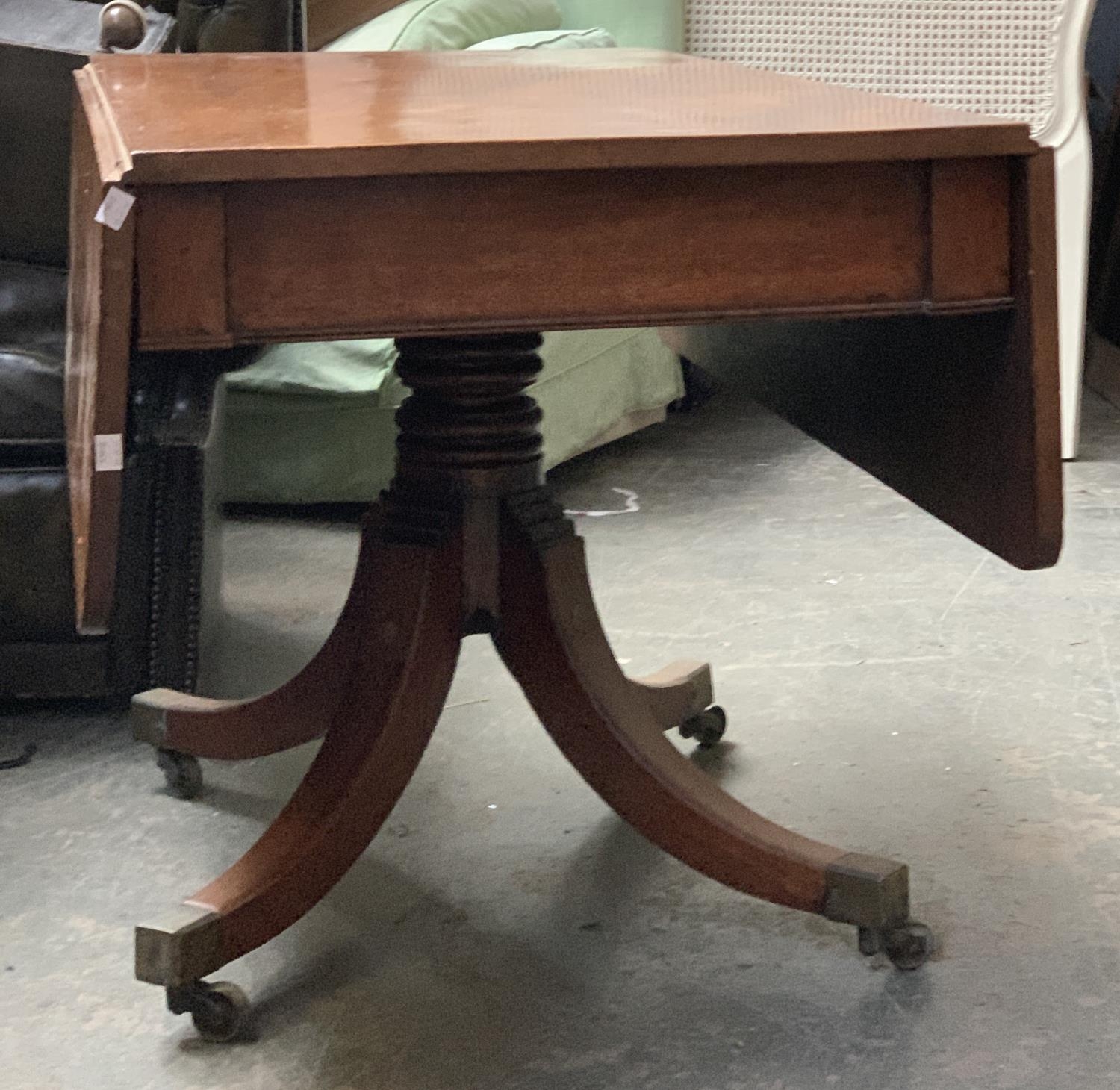 A Regency mahogany Pembroke table, on turned column, with swept legs and brass caps and casters, - Bild 2 aus 2