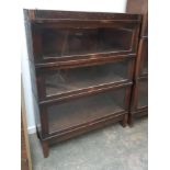An oak Globe-Wernicke three section bookcase, each section with plaque, 88x29x116cm