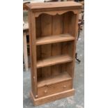 A pine bookcase with drawer below, 57cmW and 124cmH