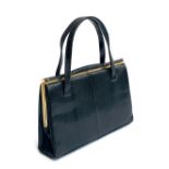 A lizard skin ladies handbag by Fassbender of London, 1950s-60s, in black with gilt metal