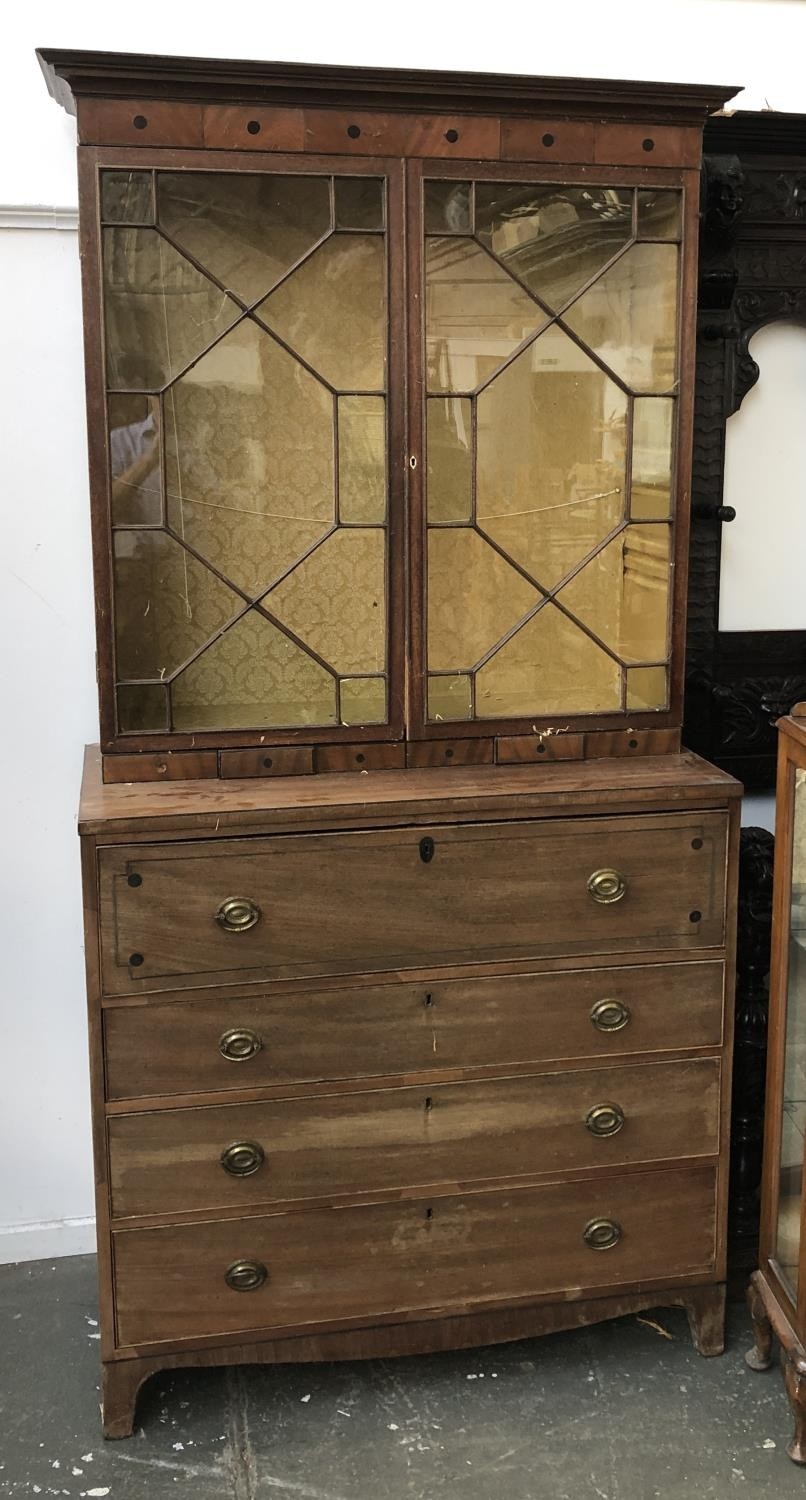 A Regency mahogany astragal glazed secretaire bookcase with fitted interior, over a further three