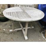 A slatted teak garden table, 120x76cmH