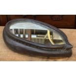An unusual mirror, set within a saddle, 48cmH