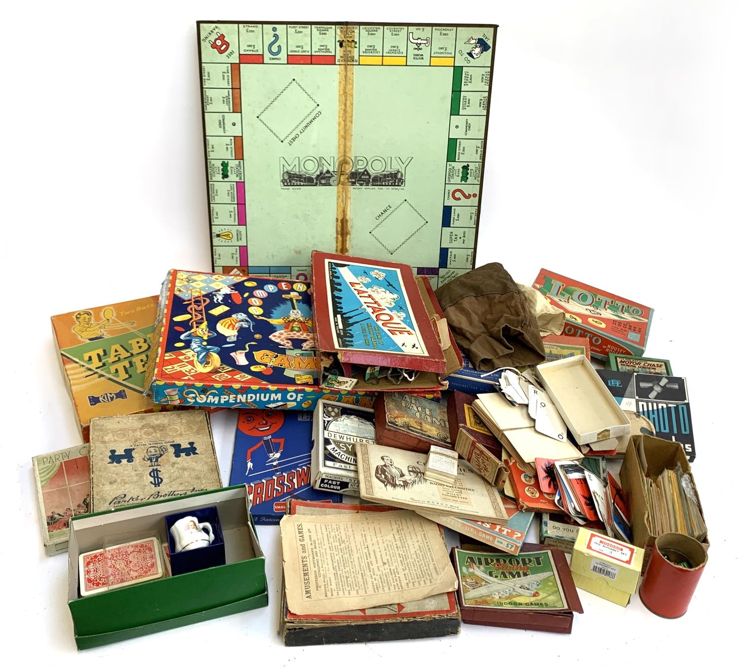 A mixed box of toys and games to include table tennis, compendium of games, cigarette cards,