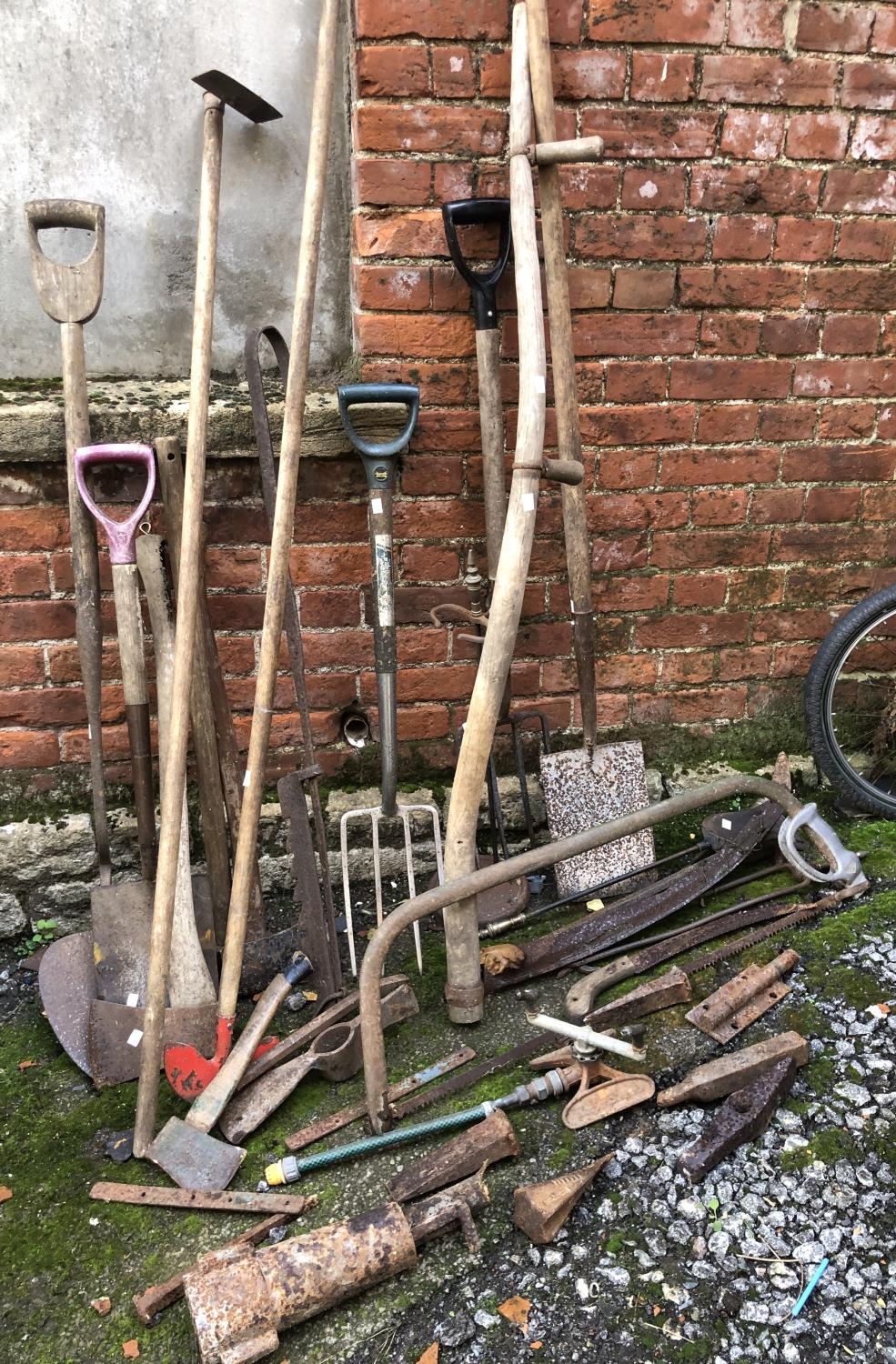 A quantity of vintage garden tools and other items to include metal wedges and a Cooper Stewart