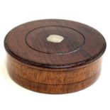 A fruitwood turned treen cylindrical box, the lid inset with white metal plaque, 10.3cmD, 3.2cmH