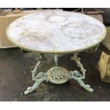 A cast iron garden table with marble top, 92cmD, 70cmH