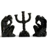 A black lustre glazed three arm candlestick holder, 29cmH, together with 2 matching figures in the