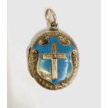 A Victorian gold engraved locket, the front with cross on a blue enamelled shield (af), the back