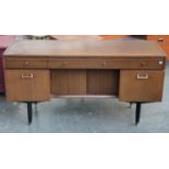 A Nathan mid century sideboard, three shallow drawers over two cupboards and kneehole with sliding