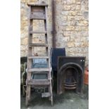 A cast iron fire surround and back plate, 61x92cm, together with a vintage stepladder (af)
