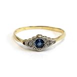 An 18ct gold and platinum ring set with a sapphire and three illusion set diamonds (one missing),