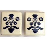 A pair of glazed terracotta delft style tiles, each 25x22cm