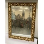 A large mirror in a gilt frame with floral decoration, 79x108cm
