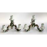 A pair of porcelain floral encrusted three arm candlestick holders (af), 20cmH