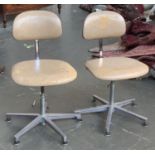 A pair of retro swivel office chairs