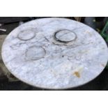 A cast iron garden table with marble top, 107cmD, 73cmH