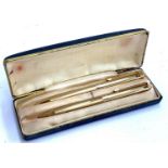 A case set comprising gold plated pen and propelling pencil, together with a pair of 925 silver earr