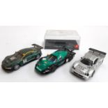 An SCX Aston Martin DBR-9, together with a Ninco Mercedes CLK, a Carrera Evolution Maserati and an