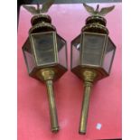 A pair of gilt metal hexagonal lanterns, surmounted by eagles