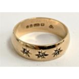 A 9ct gold gypsy ring set with three small diamonds with engraved star detail, approx. 3.3g, size