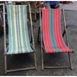 A pair of deck chairs with candy stripe canvas seats