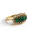 A Boodles and Dunthorpe 18ct gold, emerald and diamond cluster trilogy ring, the inner shank engrave