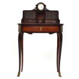 A 19th century French bureau de dame, the superstructure with central clock, over two concealed