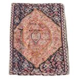 Two north West Persian kilim rugs, each with rhomboid central design within rich swirling spandrels,